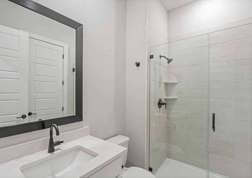 The third full bathroom has a nice vanity space and glass, walk-in shower.
