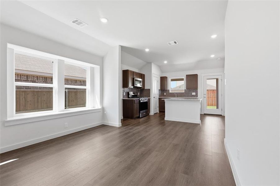 Unfurnished living room with dark wood-style floors and recessed lighting