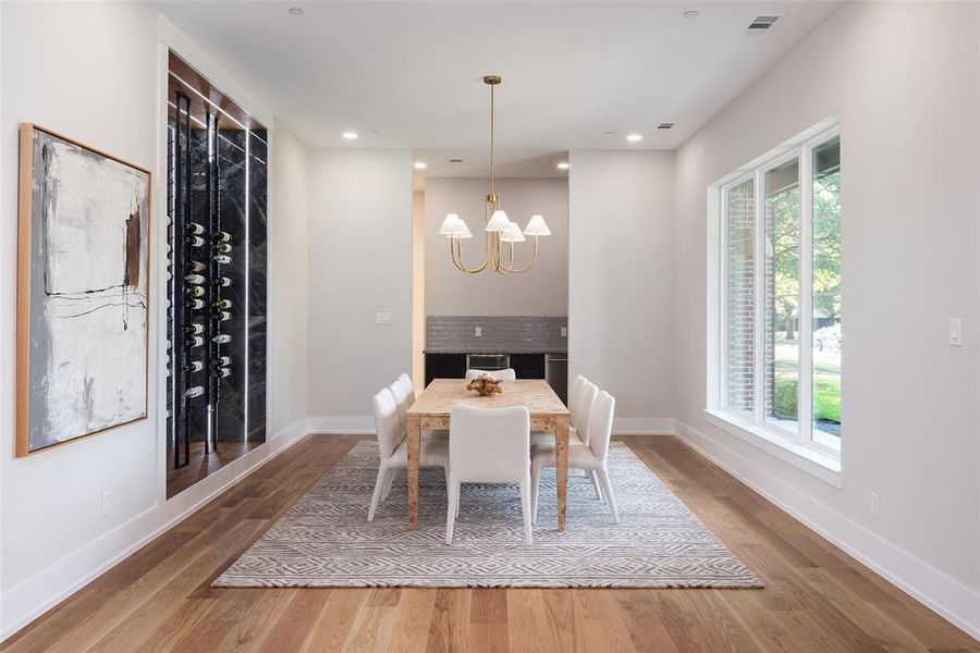 Unfurnished dining area featuring hardwood / wood-style flooring and a notable chandelier