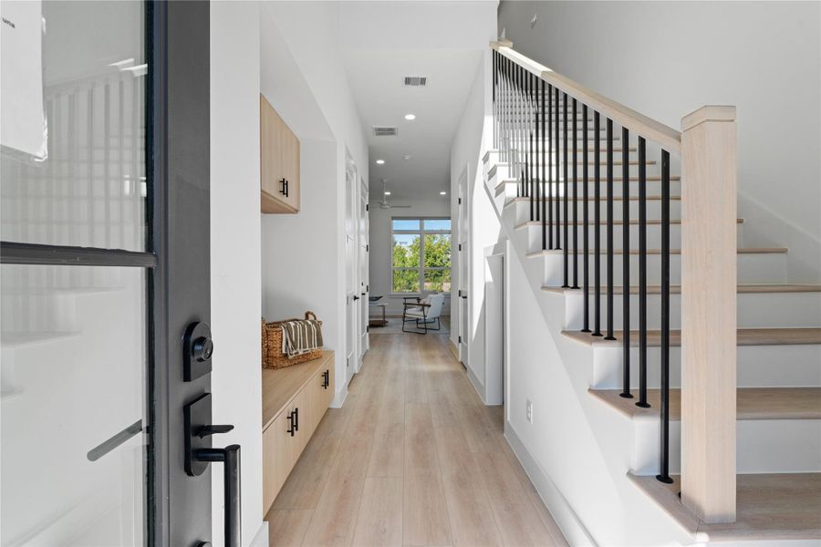 A refined entry sequence anchored by clean lines and custom millwork, with a stair design that doubles as an architectural statement while guiding natural flow through the home.