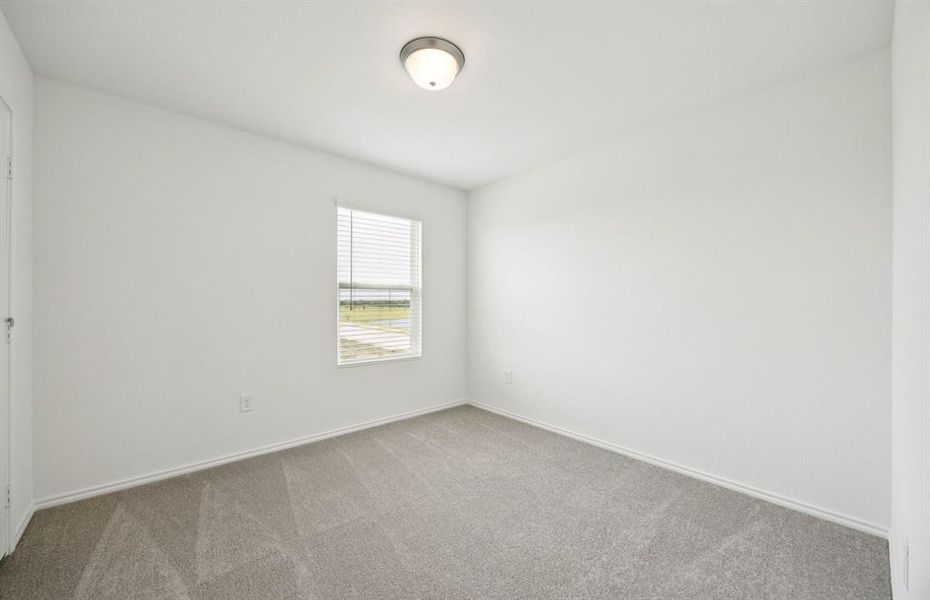 Spacious secondary bedroom with large windows