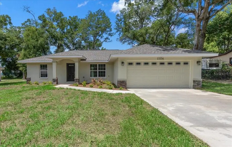 Front exterior of a new home in , Belleview, FL, highlighting curb appeal (Image 19).
