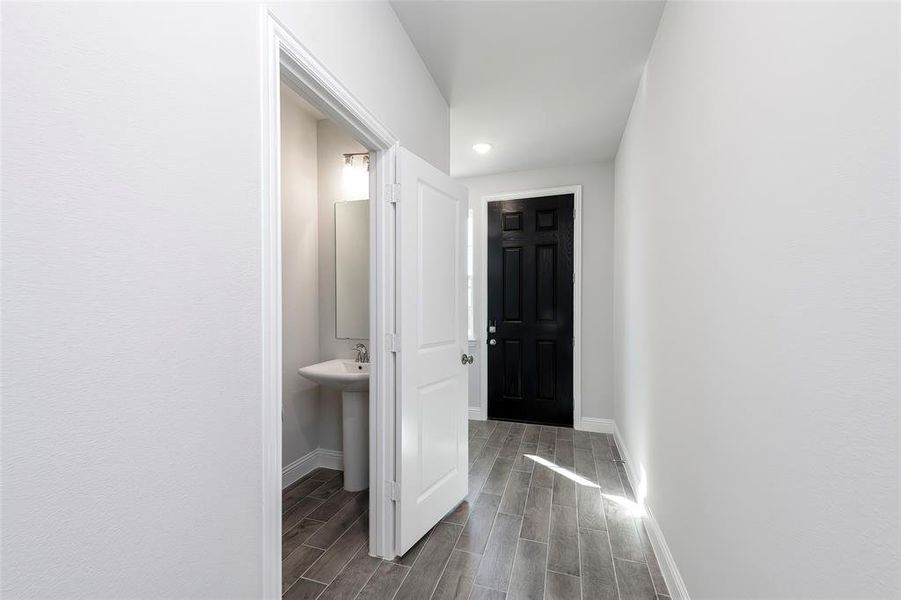 Hall with baseboards, dark wood-type flooring, and recessed lighting Hall with baseboards, dark wood-type flooring, and recessed lighting