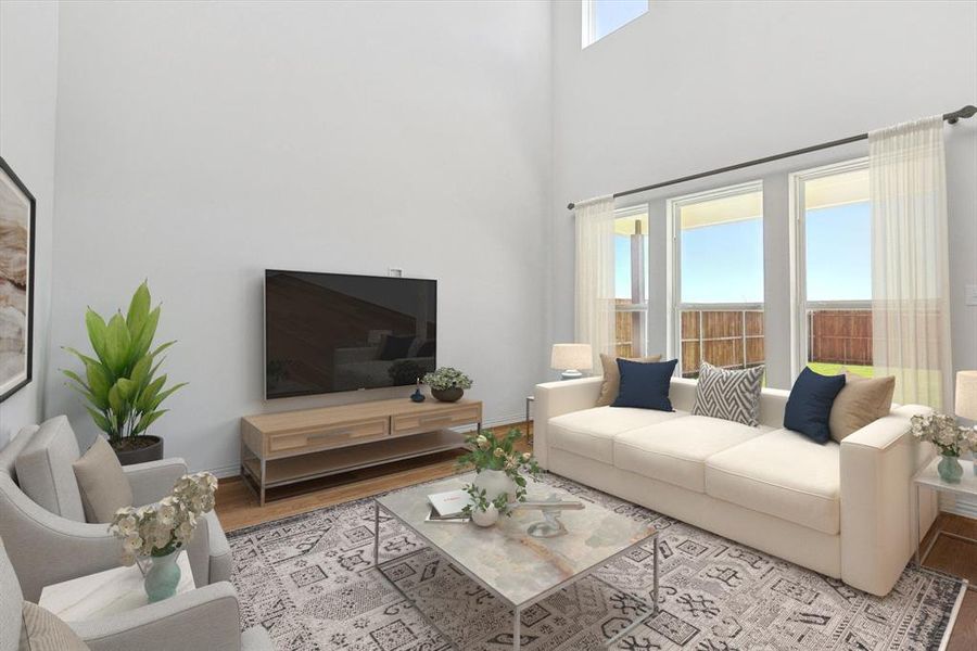 Living room with a high ceiling and light wood-type flooring