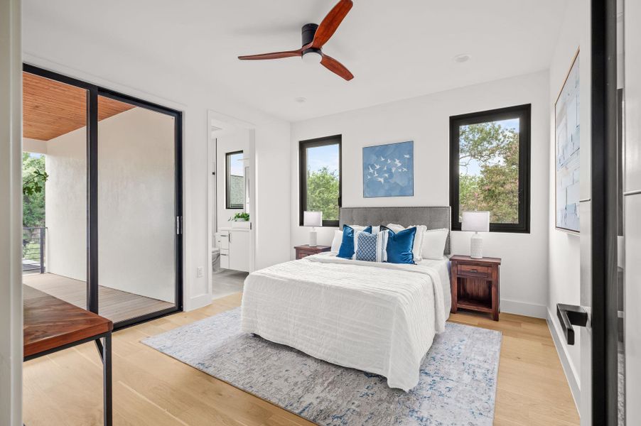 Bright bedroom suite with hardwood flooring and private balcony access. Bright bedroom suite with hardwood flooring and private balcony access.