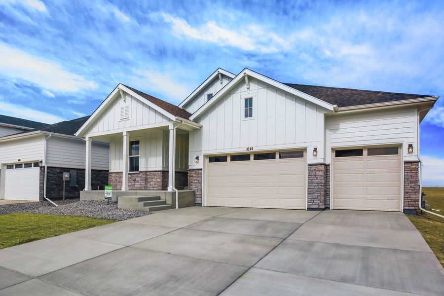 Front exterior of a new home in RainDance, Windsor, CO, highlighting curb appeal (Image 22).