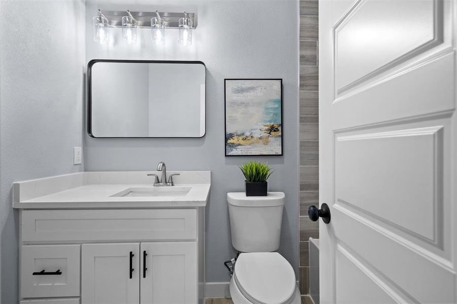 Bathroom with vanity and a textured wall Bathroom with vanity and a textured wall