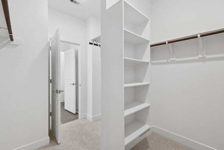 Walk-in closet in the primary suite Walk-in closet in the primary suite