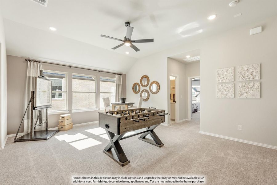 Bonus room with foosball table, vaulted ceiling, ceiling fan, and carpet flooring Bonus room with foosball table, vaulted ceiling, ceiling fan, and carpet flooring