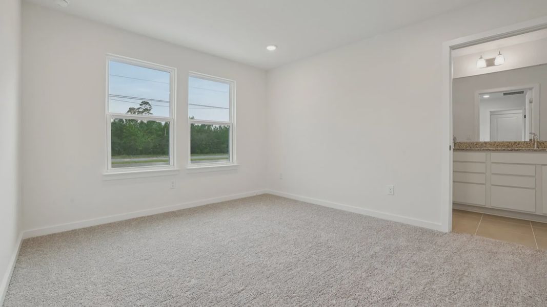 Primary suite with en suite Bath of the Coronado - End at Cyrene at Harmony located in St Cloud FL by DRB Homes