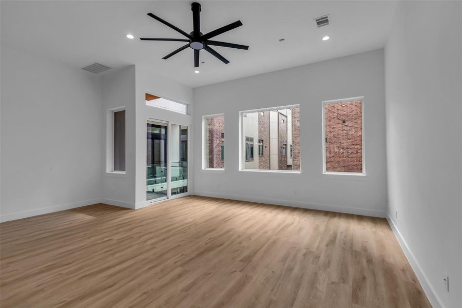 An additional view of the living area shows large windows that provide a clear sightline to the neighboring buildings. An additional view of the living area shows large windows that provide a clear sightline to the neighboring buildings.