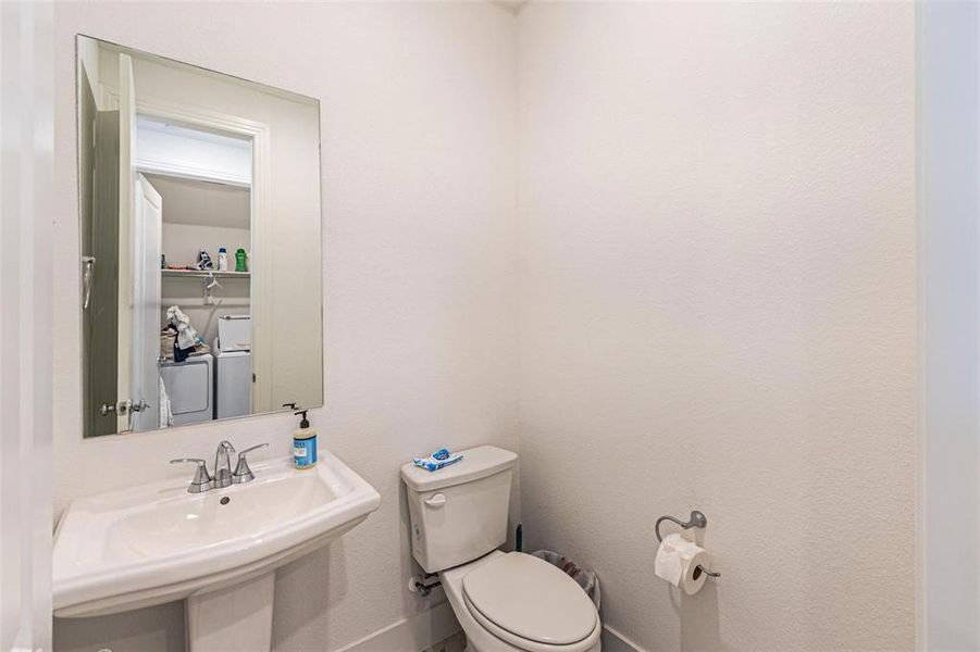 Half bath featuring toilet and a sink