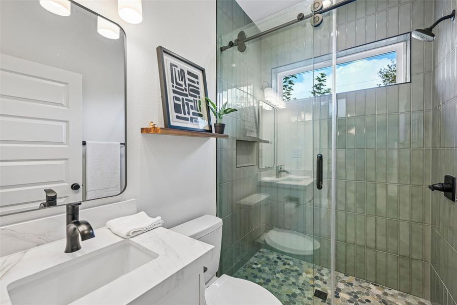 Beautiful first floor full bathroom with a spacious walk-in shower and modern fixtures.