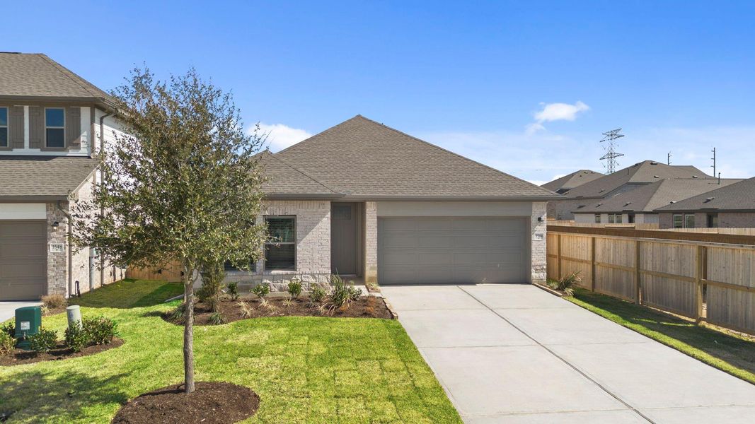 Front exterior of a new home in Windrose Green, Angleton, TX, highlighting curb appeal (Image 20).