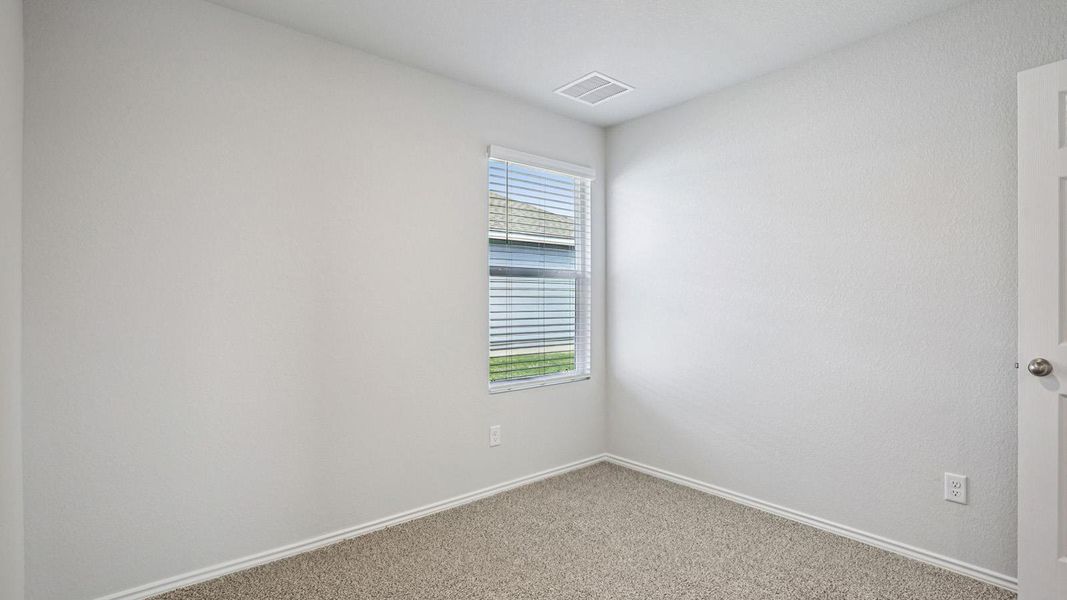 A well-lit, quiet bedroom awaits personalization with its neutral palette.