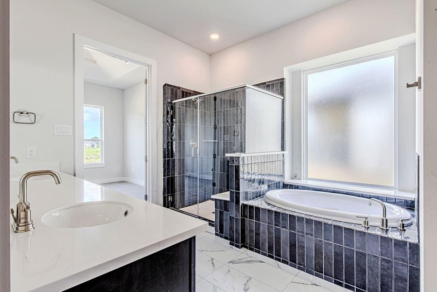 Another view of the luxurious primary bath showcasing extended counter space and storage. Another view of the luxurious primary bath showcasing extended counter space and storage.