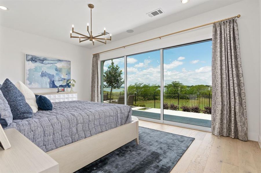 Bedroom with light wood-type flooring, recessed lighting, a chandelier, and access to outside Bedroom with light wood-type flooring, recessed lighting, a chandelier, and access to outside