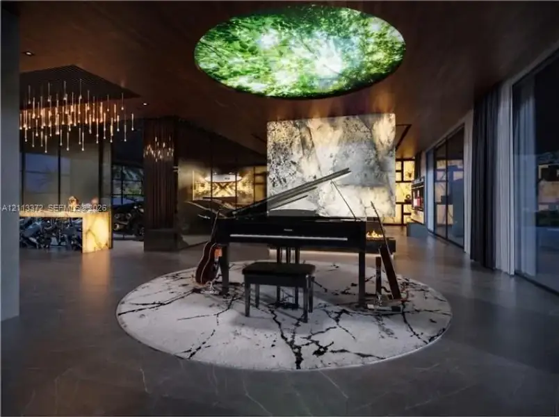 Large-format tile flooring, wood-paneled ceiling, integrated circular illuminated ceiling feature, and backlit stone accent wall