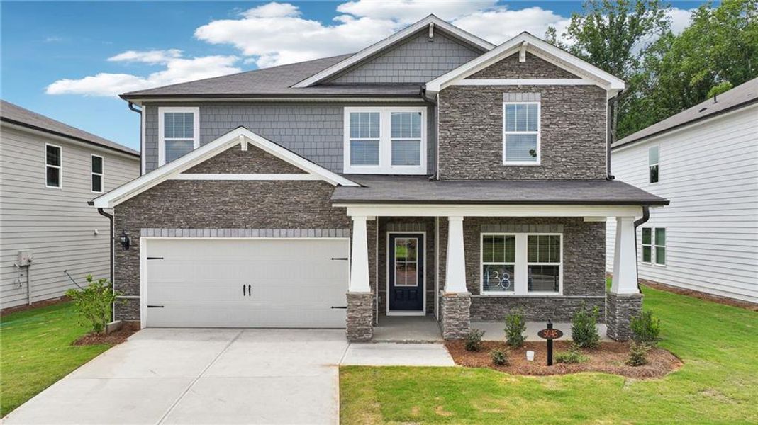 Front exterior of a new home in Vines at Mill Creek - Estate Series, Braselton, GA, highlighting curb appeal (Image 1).
