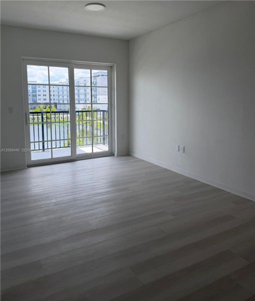 Living room with direct views of the private balcony and tranquil lake, perfect for winding down after a long day.