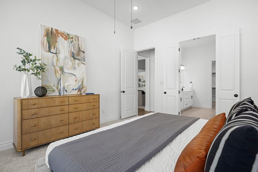 Bedroom featuring connected bathroom, recessed lighting, and light colored carpet