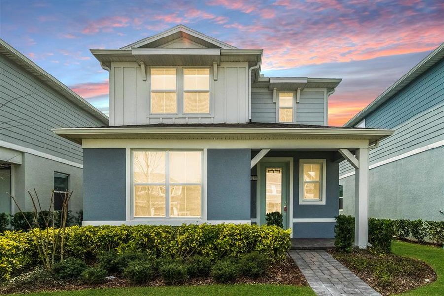 Front exterior of a new home in Isles of Lake Nona, Orlando, FL, highlighting curb appeal (Image 26).