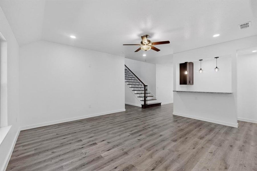 Unfurnished living room with light wood-style floors, stairway, recessed lighting, and a ceiling fan