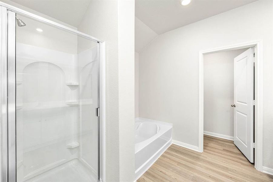 The bathroom has a beautiful, upgraded step in shower with a large glass door.