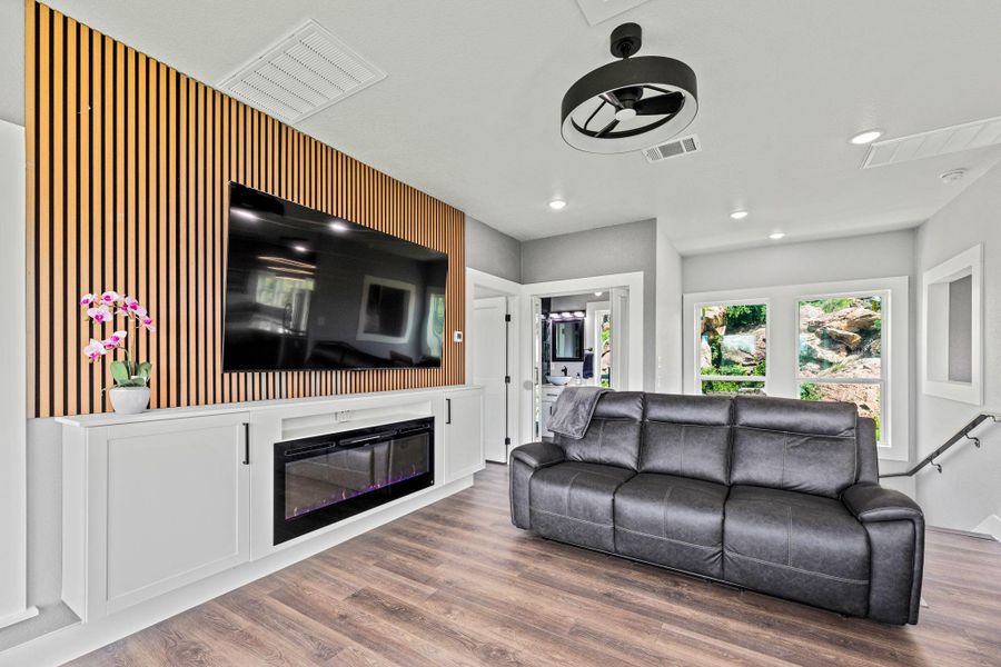Feature wall with vertical wood slat detailing and integrated electric fireplace