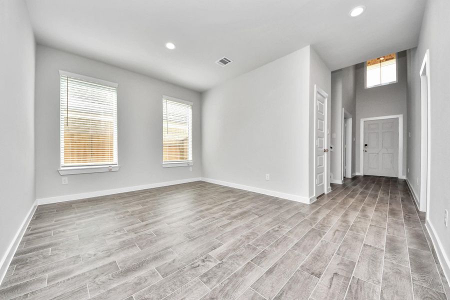 Craft enduring memories with loved ones around the table in this roomy dining area. It boasts stylish flooring, personalized paint, and is conveniently situated next to the family room and kitchen, fostering an open and inclusive ambiance.