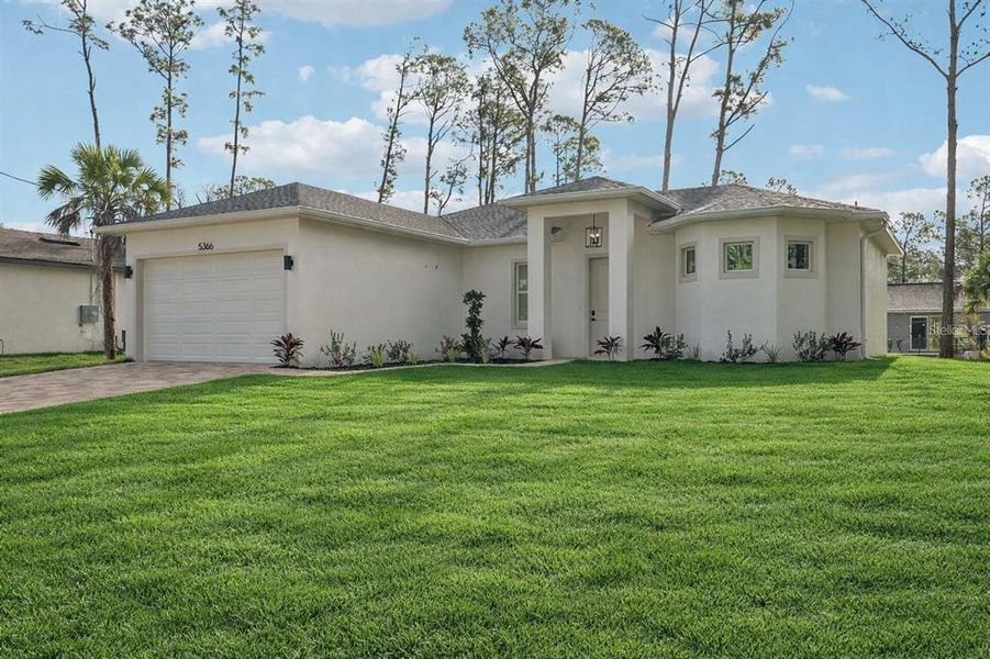 Front exterior of a new home in , North Port, FL, highlighting curb appeal (Image 2). Front exterior of a new home in , North Port, FL, highlighting curb appeal (Image 2).