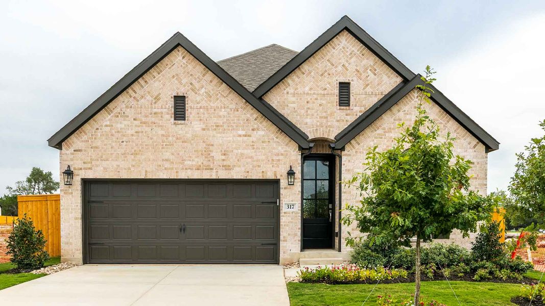 Front exterior of a new home in Woodside 47', Georgetown, TX, highlighting curb appeal (Image 1).