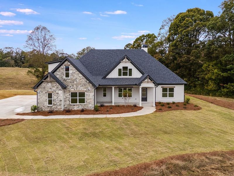 Front exterior of a new home in Parmer Farms, Roopville, GA, highlighting curb appeal (Image 1).
