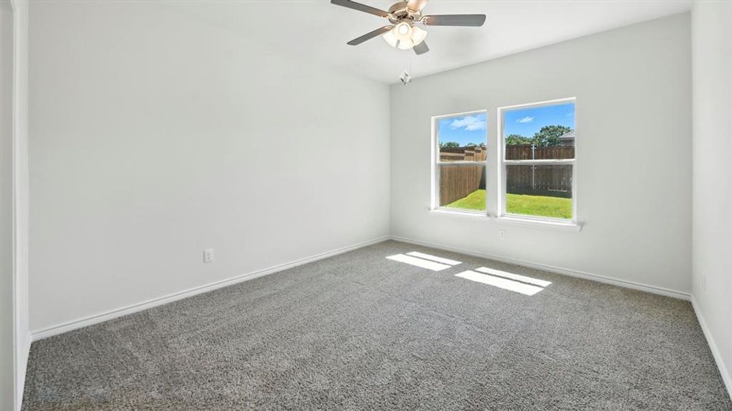Spare room with carpet floors and ceiling fan Spare room with carpet floors and ceiling fan