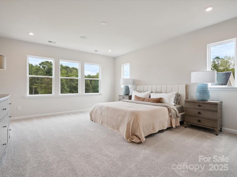Generously Sized Primary Suite Surrounded by Windows and Unobstructed Views.  *Model Photos | Actual Finishes, Structural Selections, and Orientation May Vary.