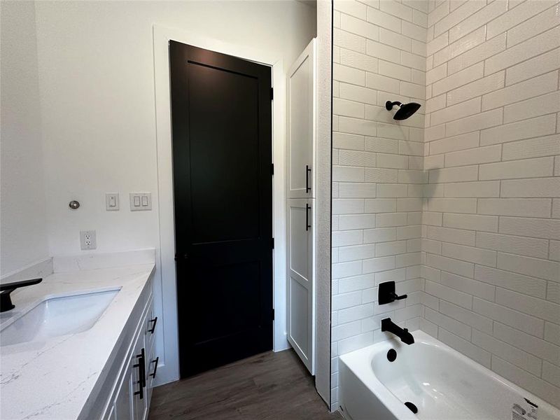 2nd Bath with cabinets behind the door