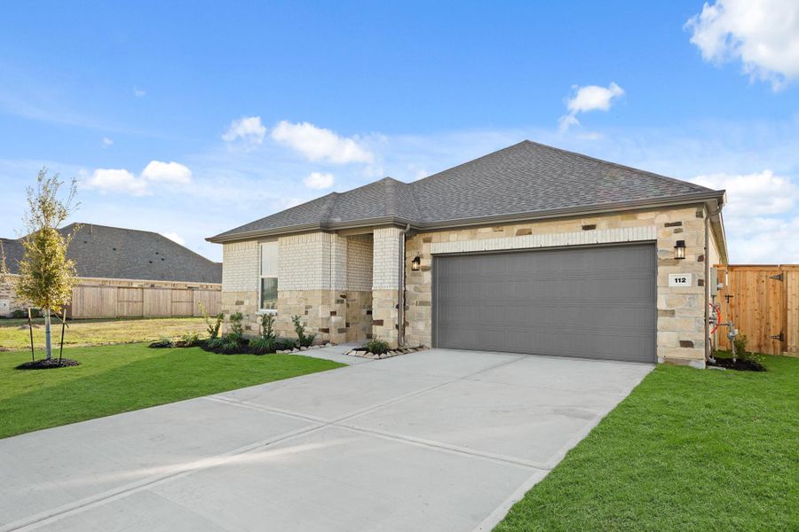 Front exterior of a new home in Woodshore, Clute, TX, highlighting curb appeal (Image 22).