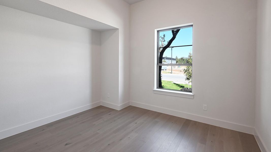 Unfurnished room with baseboards and wood finished floors Unfurnished room with baseboards and wood finished floors
