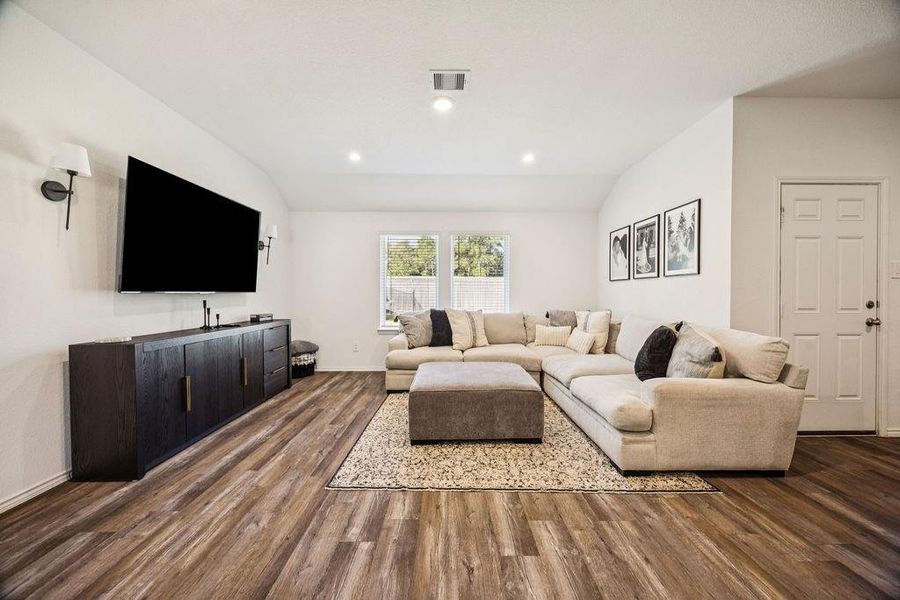 Spacious and inviting living room featuring elegant wood floors, ample natural light, and a modern entertainment center. Perfect for relaxation and gatherings. Spacious and inviting living room featuring elegant wood floors, ample natural light, and a modern entertainment center. Perfect for relaxation and gatherings.