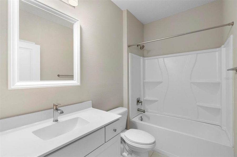 A full bath is conveniently located between the two guest rooms, offering easy access for guests and seamlessly connecting to the living area for added convenience.