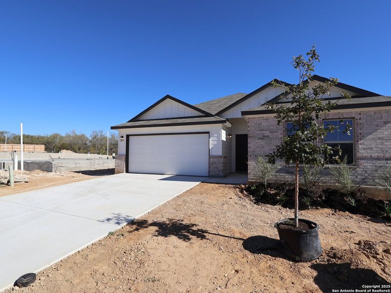 Front exterior of a new home in Greenspoint Heights, Seguin, TX, highlighting curb appeal (Image 21). Front exterior of a new home in Greenspoint Heights, Seguin, TX, highlighting curb appeal (Image 21).
