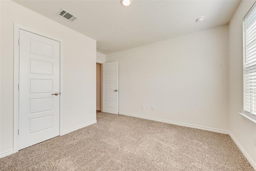 Unfurnished bedroom with carpet flooring and recessed lighting Unfurnished bedroom with carpet flooring and recessed lighting