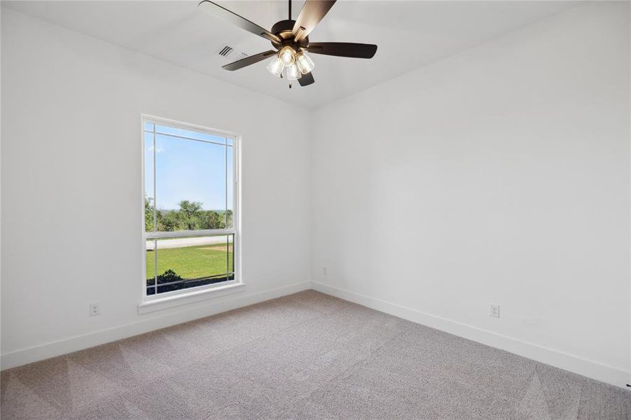 Empty room with carpet and ceiling fan