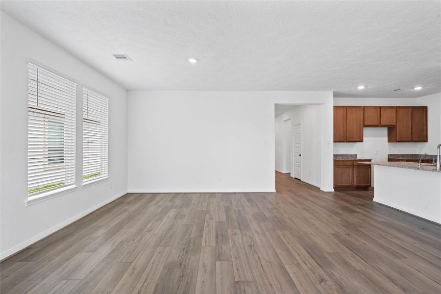 Start your day with a warm cup of coffee and quality time in this charming dining area! Highlights include large windows, custom neutral paint, tile flooring, and high ceilings with recessed lighting.