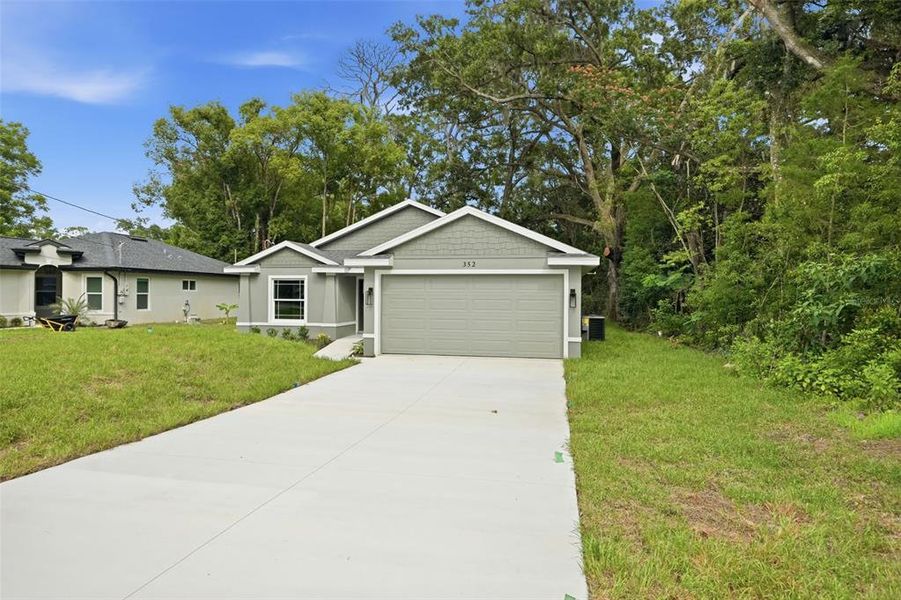 Front exterior of a new home in , Masaryktown, FL, highlighting curb appeal (Image 26).