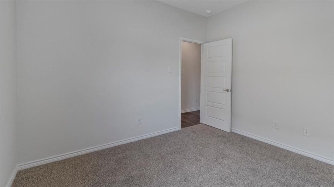 Unfurnished room featuring baseboards and carpet Unfurnished room featuring baseboards and carpet