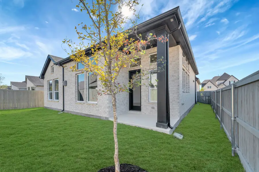 Exterior details and patio area of a home in Pecan Square - Gardens, Northlake (Image 4).