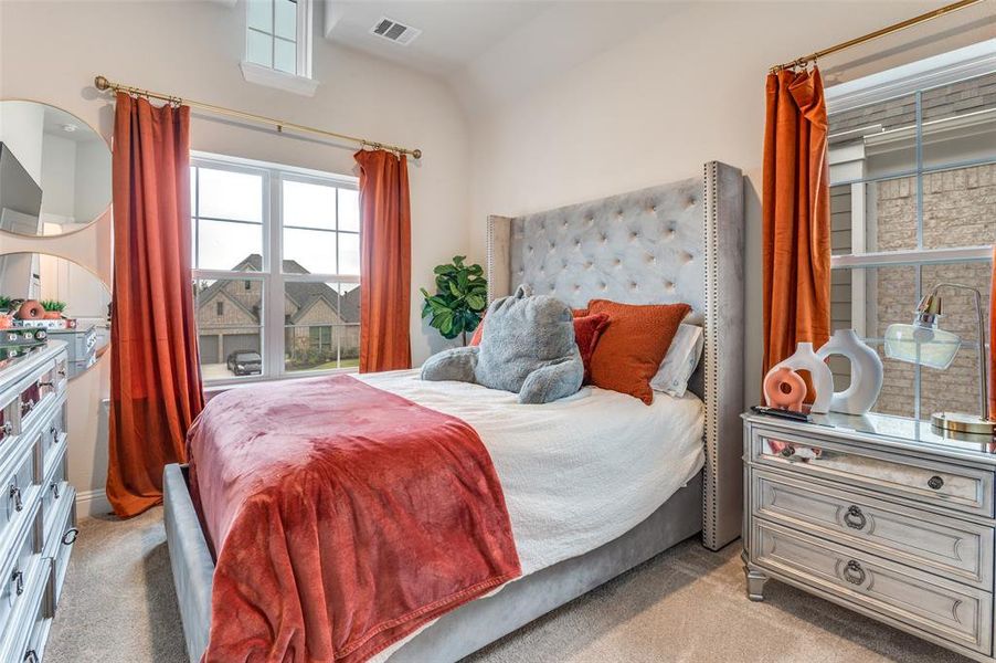 Bedroom with light colored carpet