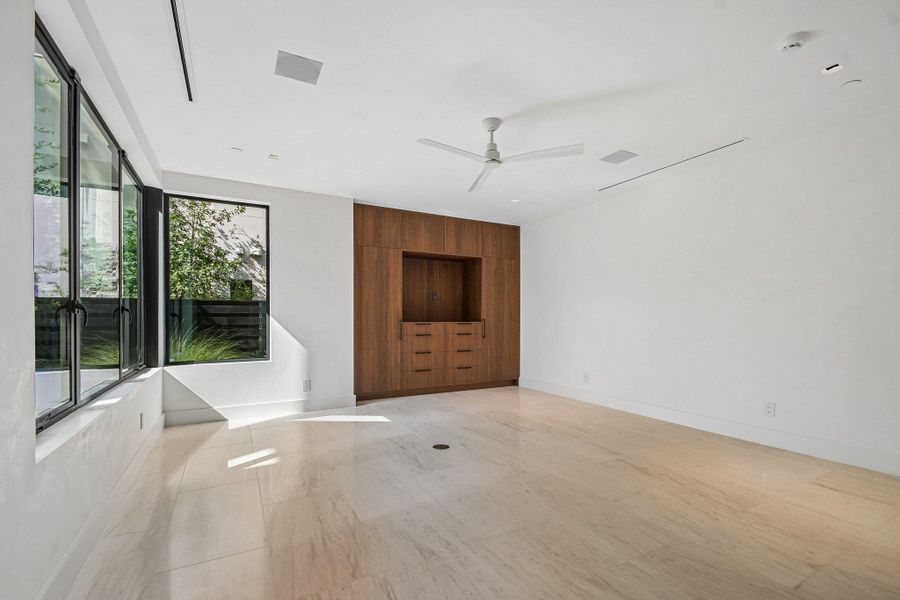 Clean lines and custom wood cabinetry define this versatile living space with light-filled windows. Clean lines and custom wood cabinetry define this versatile living space with light-filled windows.