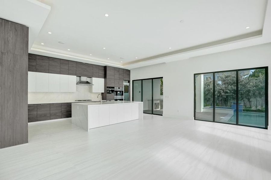Open-Concept Kitchen Flowing into Dining and Living Areas.